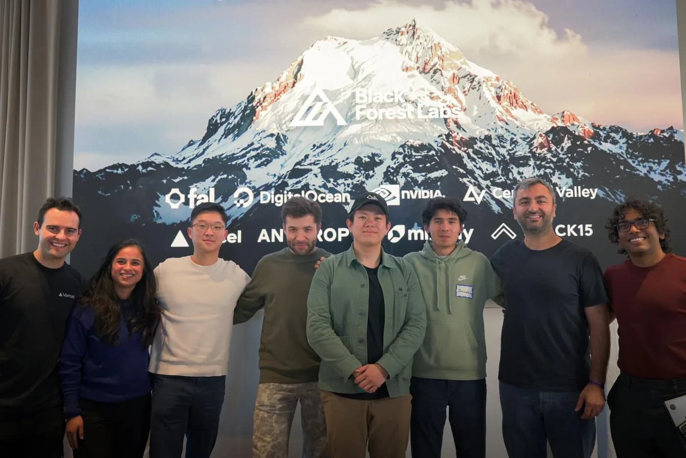 Javokhir Shomuratov and his team with the Hack FLUX: Beyond One organizers in front of the Black Forest Labs stage